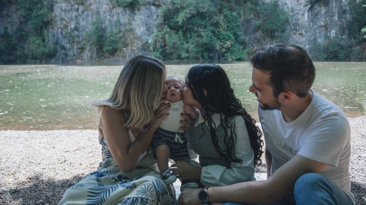 Family enjoying quality time together by the scenic riverside backdrop.
